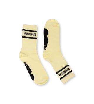 We Rde Local Division Banana Socks-side view, yellow cotton socks with black "We Ride Local" logo on the cuff.